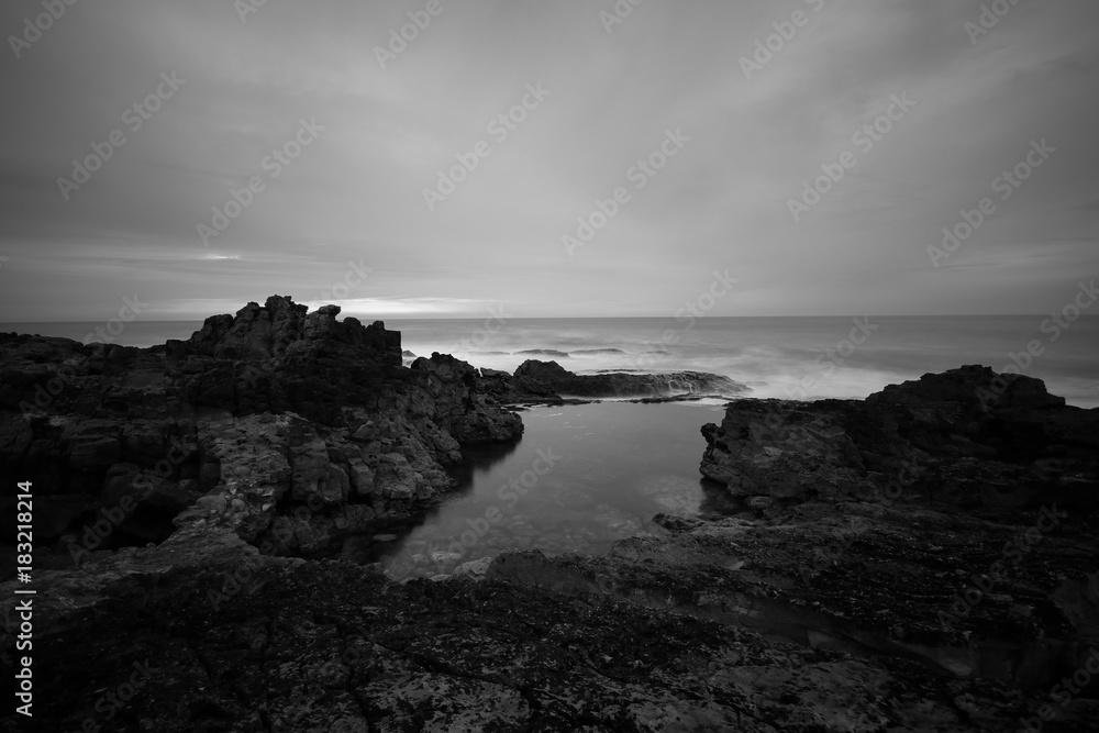 Long exposure in amazing Wild rock beach at the sunset. Sintra Cascais Natural park