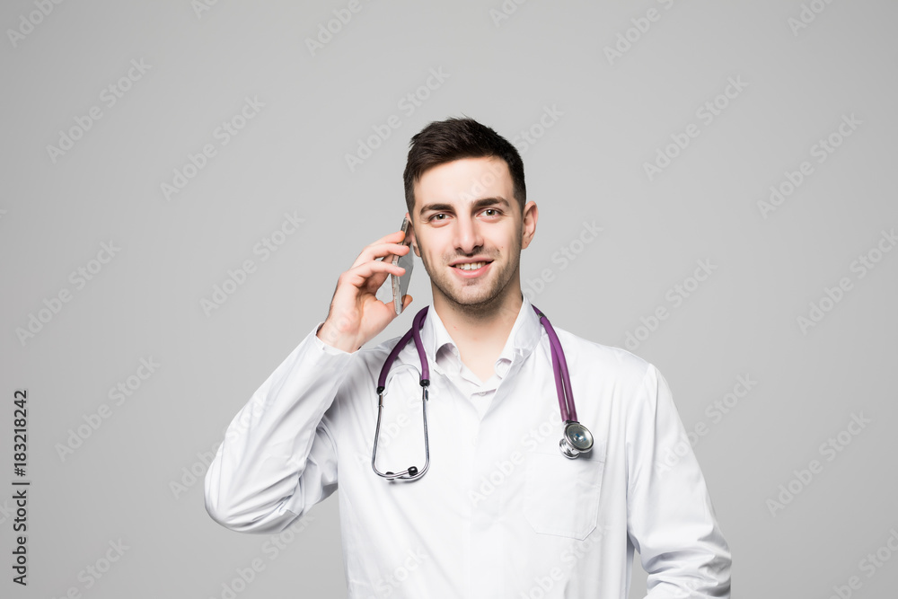 Portrait of handsome young doctor talking by phone isolated on white background Portrait of handsome young doctor talking by phone isolated on white background