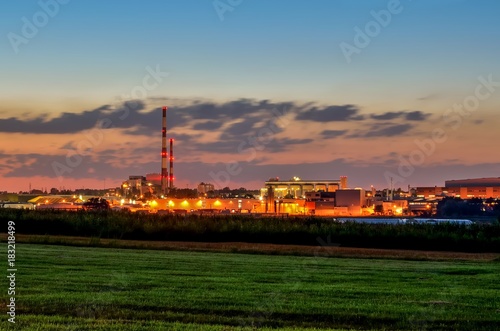 Night industrial landscape. Glowing factories in the city.