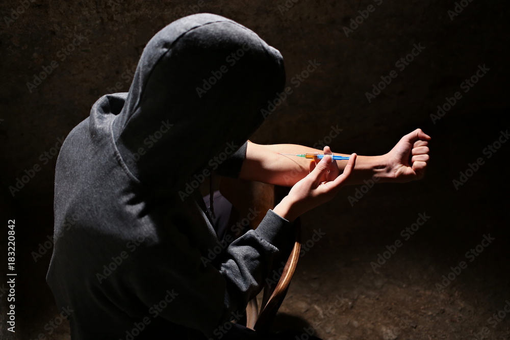 Drugs concept. Disease concept. Drug addict man with syringe using drugs.Dark  theme, young guy very stressed, He would drug addiction. Stock-foto | Adobe  Stock