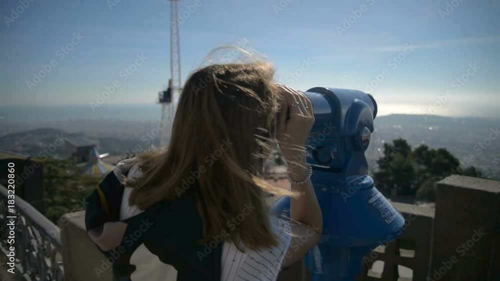 Tourist, Girl looks in Binoculars at Barcelona Tourist, Girl looks in Binoculars at Barcelona