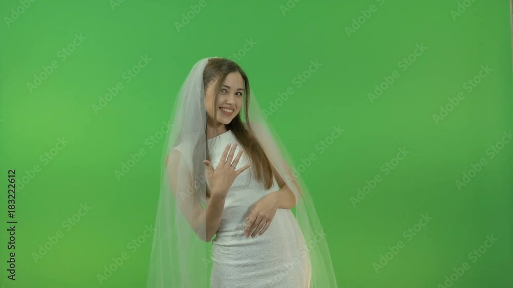 Young white girl in a bride dress, on a green background. Young white girl in a bride dress, on a green background.