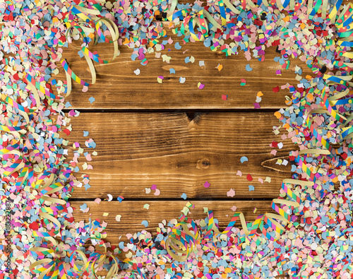 confetti and streamer on a wooden background