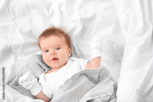 Cute little baby lying on b...
