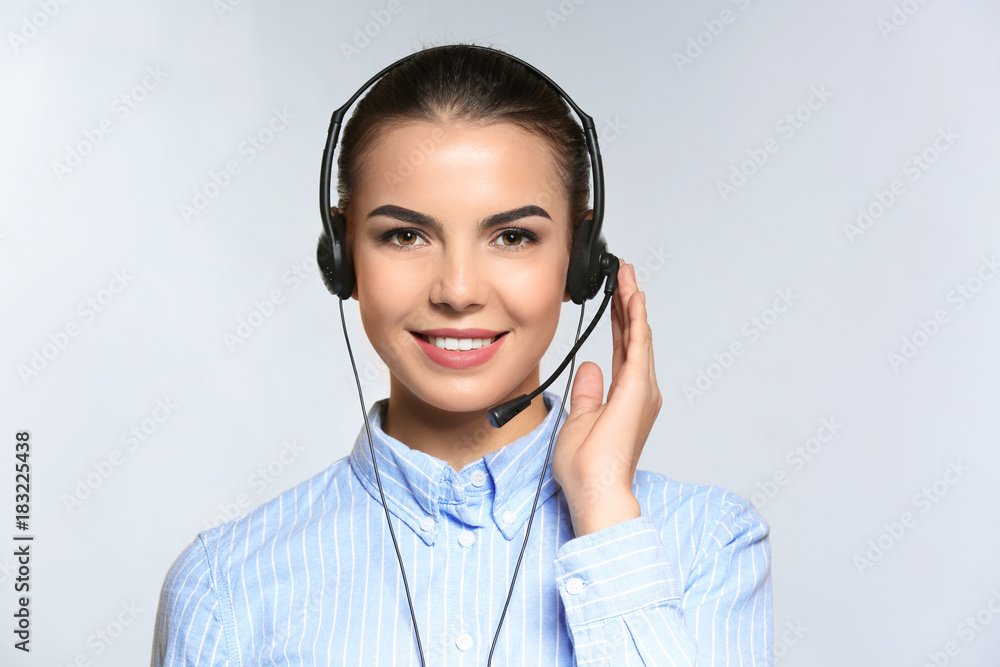 Female consulting manager with headset on light background Female consulting manager with headset on light background