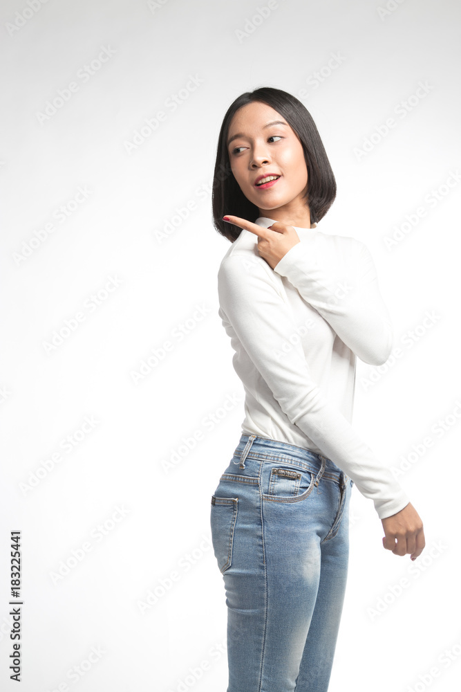 Beautiful young asian woman pointing at whitespace Beautiful young asian woman pointing at whitespace