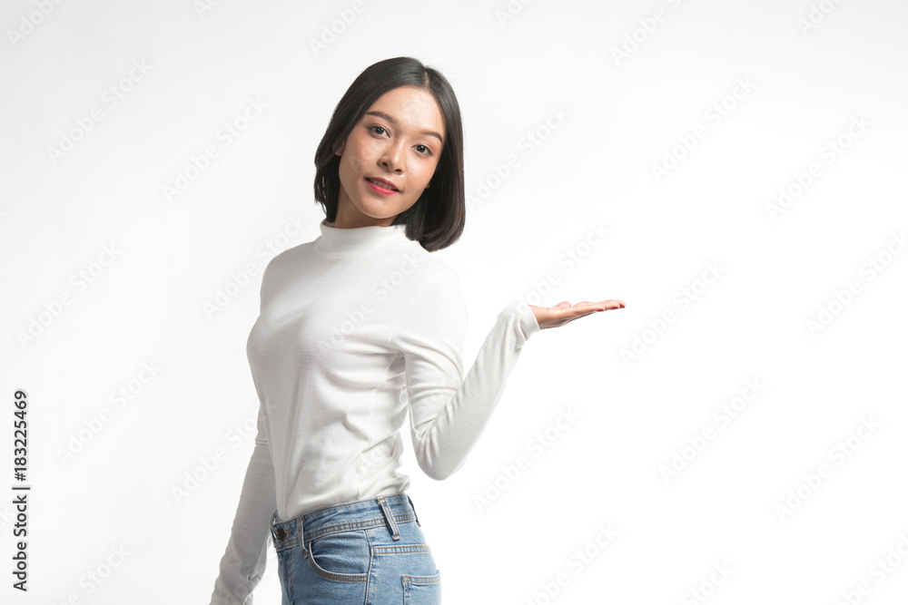 Beautiful young asian woman pointing at whitespace Beautiful young asian woman pointing at whitespace