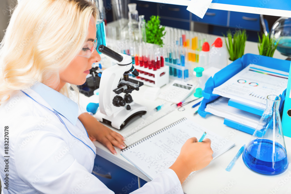 Young attractive woman scientist researching in the laboratory Young attractive woman scientist researching in the laboratory