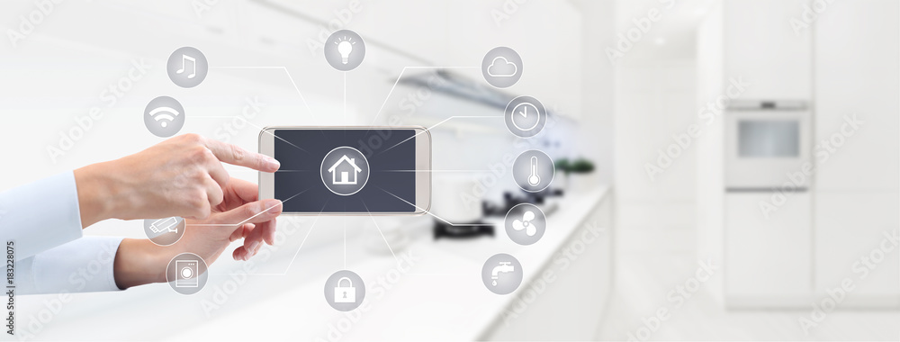 home automation hand touch smart phone screen with symbols on kitchen blurred background home automation hand touch smart phone screen with symbols on kitchen blurred background