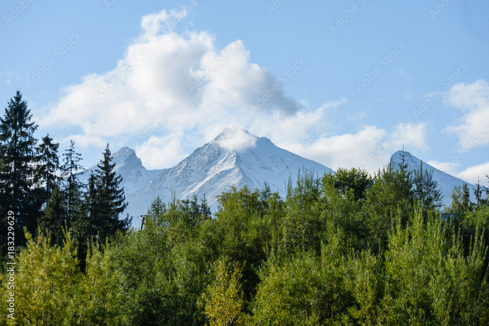 mountain tops in autumn covered in mist or clouds in sunny day mountain tops in autumn covered in mist or clouds in sunny day
