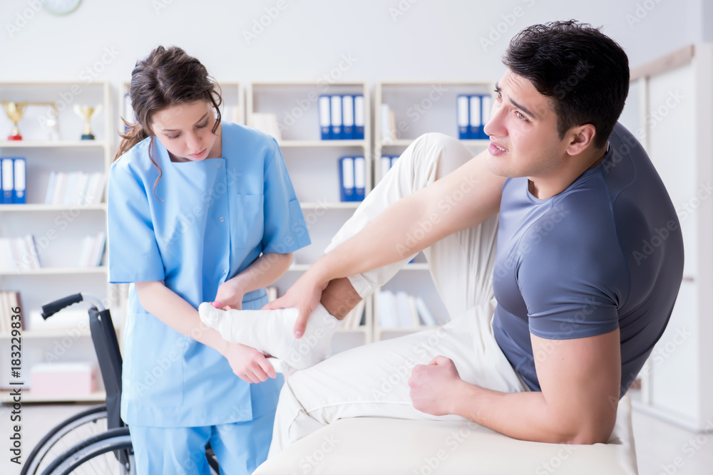Fototapeta premium Doctor and patient during check-up for injury in hospital