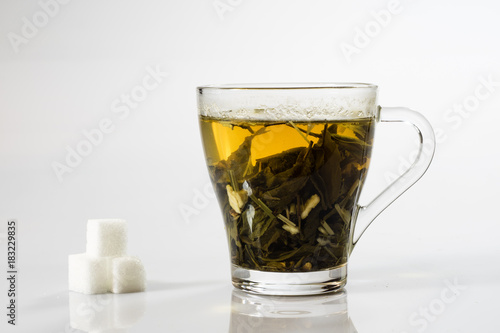Tea in a glass on a white background. Green or fruit tea.