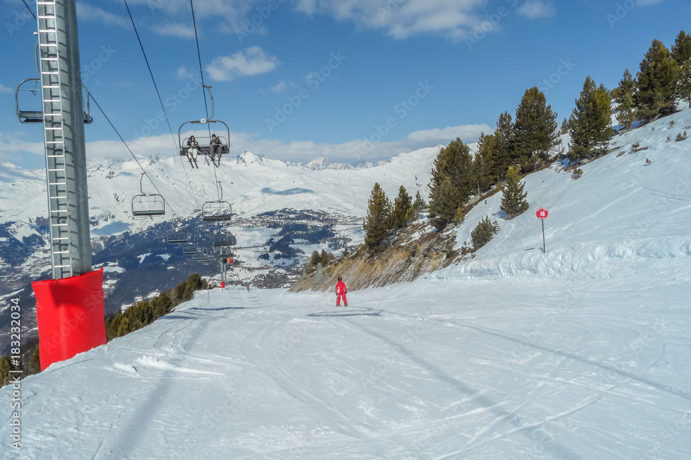 Skiing in the mountains of  ski area  Les arcs - La Plagne, France.