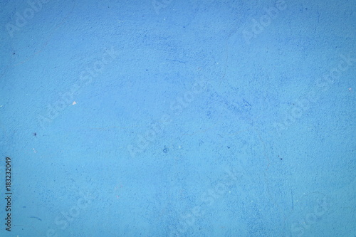Background of a blue stucco coated and painted exterior, rough cast of cement and concrete wall texture, decorative rustic coating
