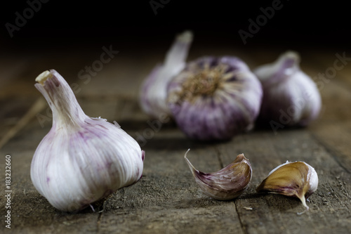Tasty Italian garlic in an old kitchen on a wooden table