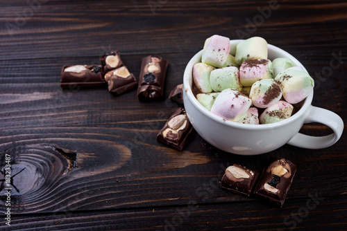 Cup of hot chocolate and marshmallow on wooden background