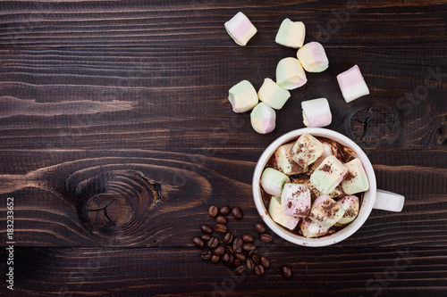 Cup of hot chocolate and marshmallow on wooden background, top view. Christmas drink.