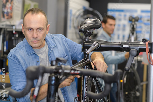man checks a bike before buying in the sports shop