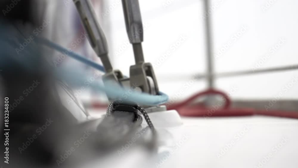 Winch and rope close up on sailing vessel slow motion. Regatta in ocean.
