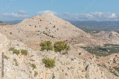 Stony landscape with trees of the Tsambika mountain on the Rhodes Island, Greece photo