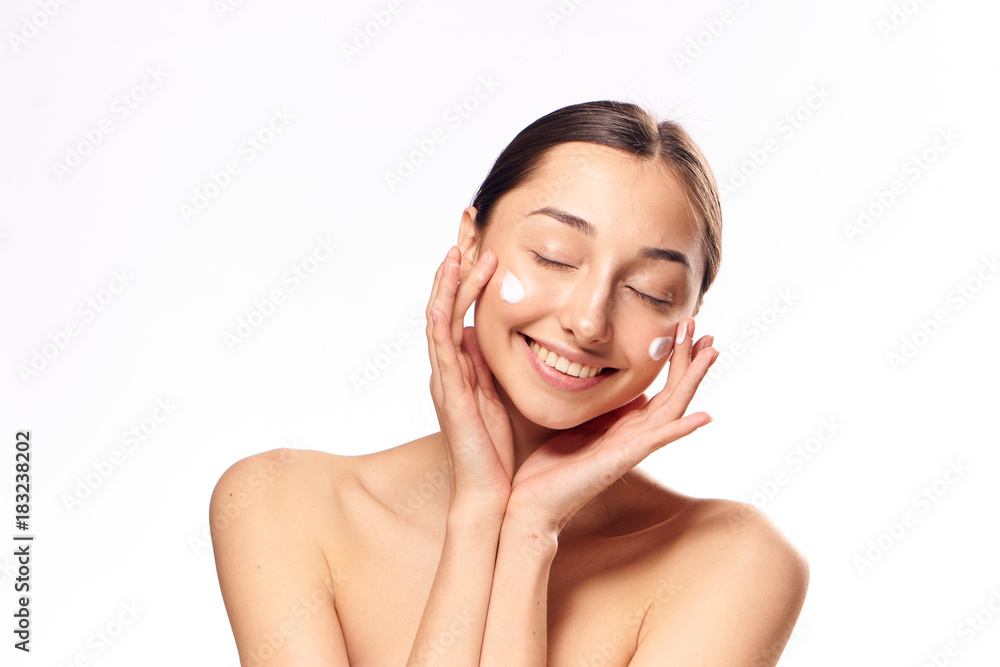 2046258 young woman, cream on face, light background 2046258 young woman, cream on face, light background