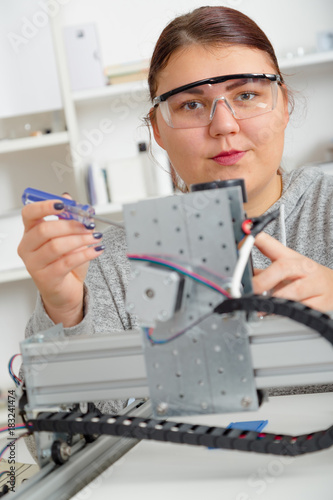 Female Apprentice working  on CNC machinery.