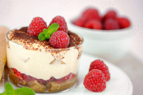 Tiramisu with fresh raspberries - traditional italian dessert.