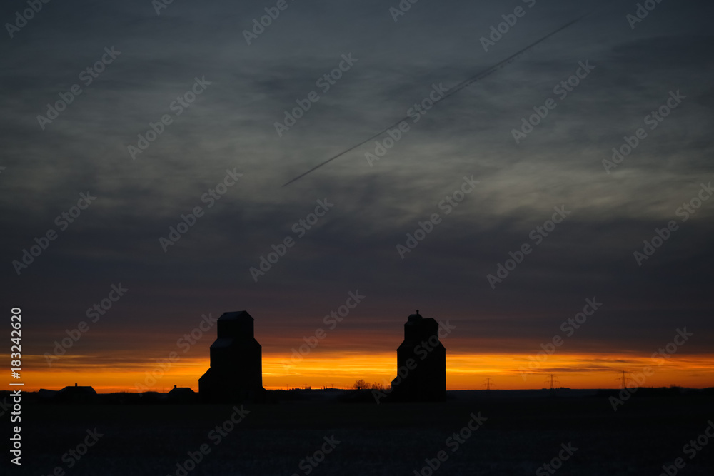 prairie grain elevators at sunset