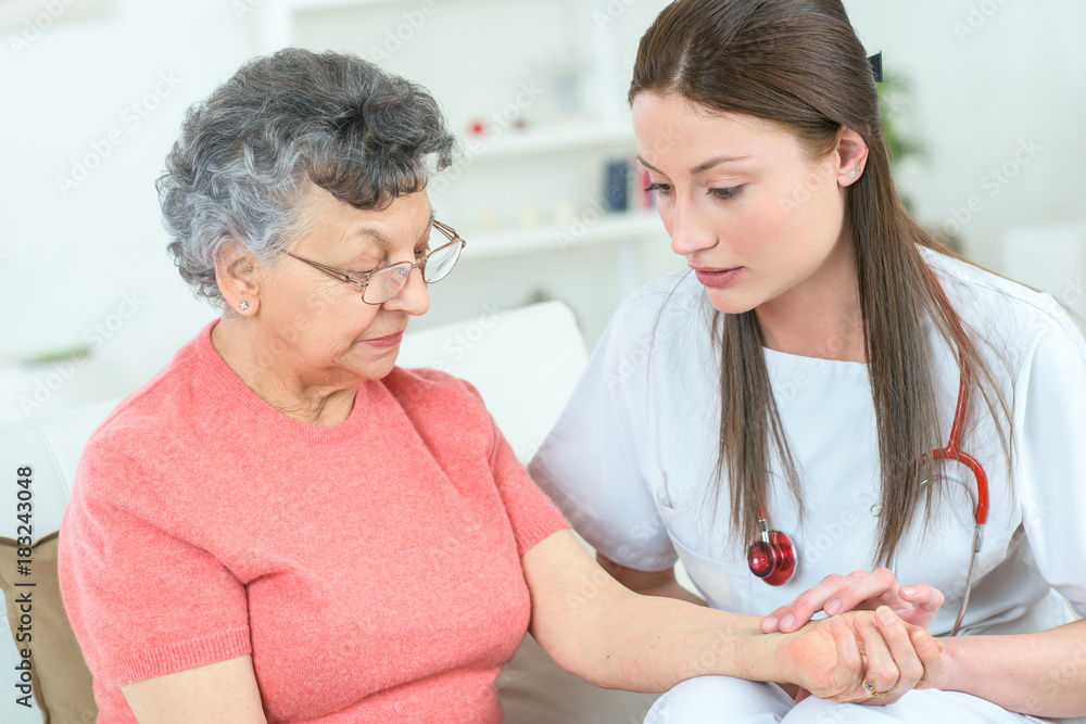 pleasant professioanl doctor examining her patient at home pleasant professioanl doctor examining her patient at home
