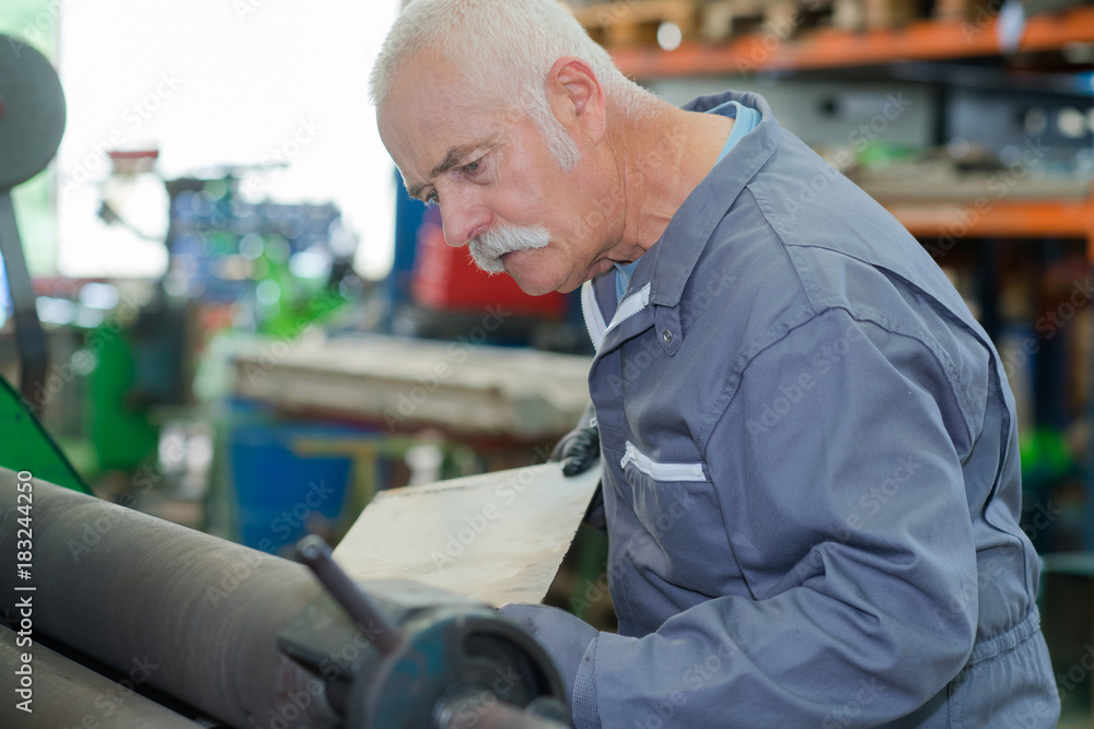 old mechanic working in a factory old mechanic working in a factory