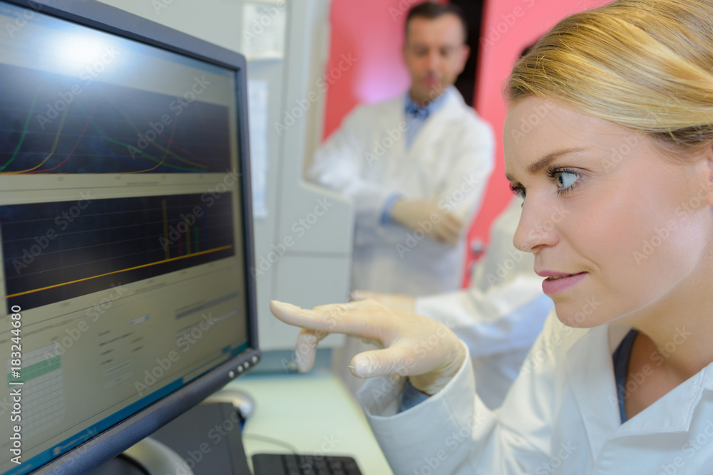 Medical worker pointing to computer screen Medical worker pointing to computer screen