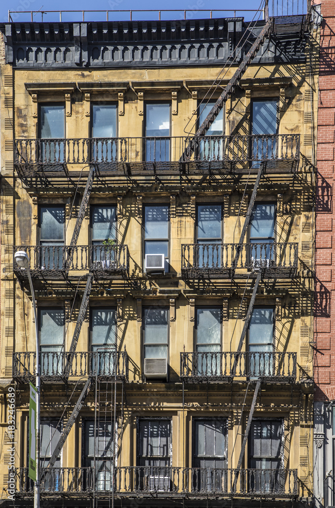 iron fire ladder at the facade of an old historic house in New York