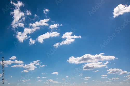 White spindrift clouds on blue sky