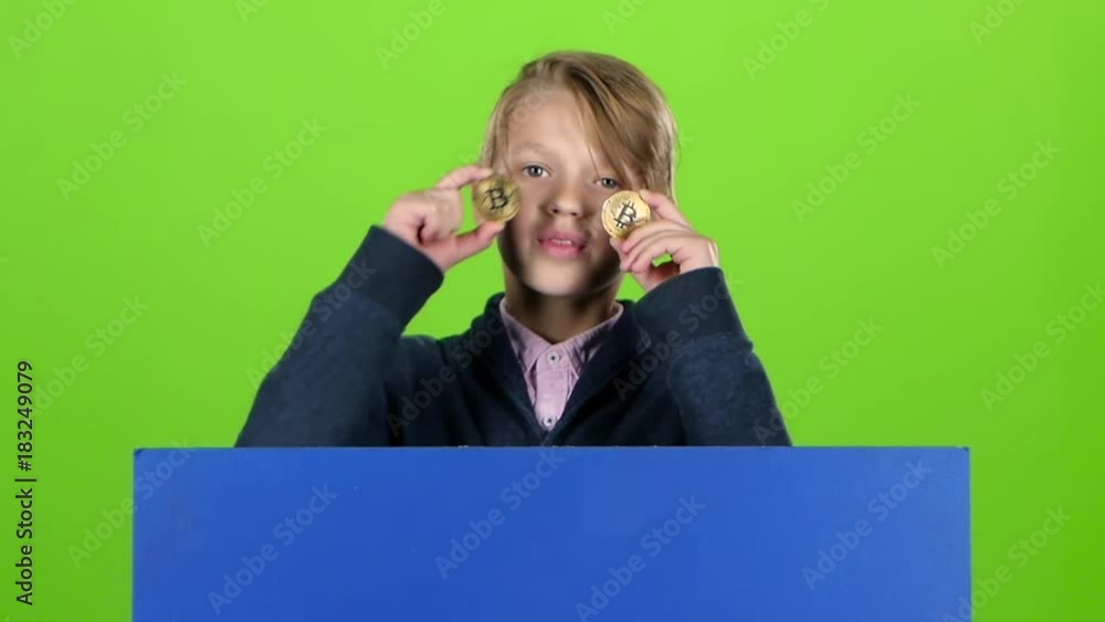 Teen emerges from behind the board with two chips and shows tongue on a green screen. Slow motion Teen emerges from behind the board with two chips and shows tongue on a green screen. Slow motion