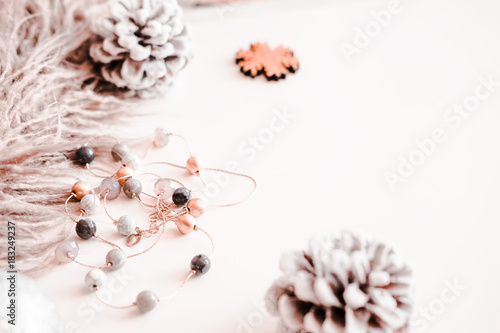 Woman Christmas background on white. Frosty pine cones, silver colored decoration balls, faux fur, jewelry. Copyspace for text, overhead, horizontal