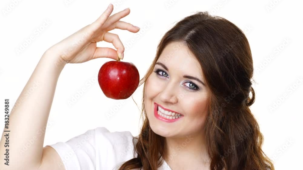 Woman toothy smile brunette female holding red apple fruit in hand close to face, isolated on white. Healthy eating, vegetarian food, diet concept. Woman toothy smile brunette female holding red apple fruit in hand close to face, isolated on white. Healthy eating, vegetarian food, diet concept.