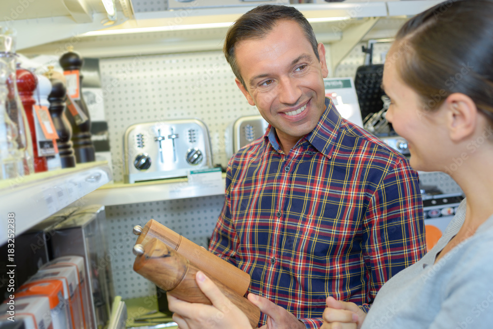Couple looking at salt and pepper grinders Couple looking at salt and pepper grinders