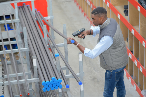 worker with portable barcode scanner in warehouse