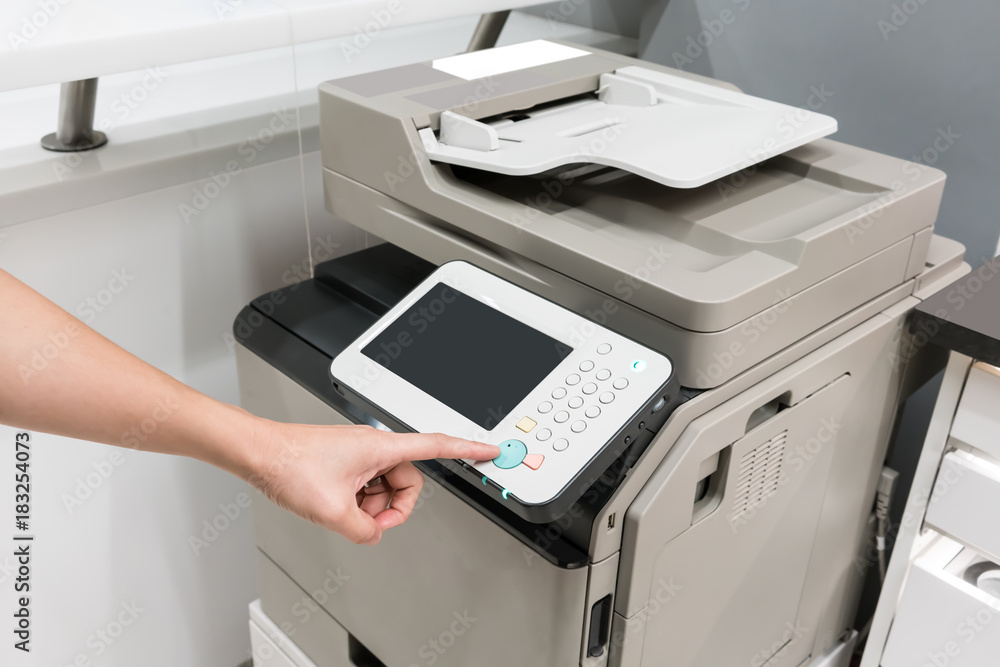 Woman's hands pressing button on copy machine Woman's hands pressing button on copy machine