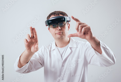 Doctor uses augmented reality goggles.