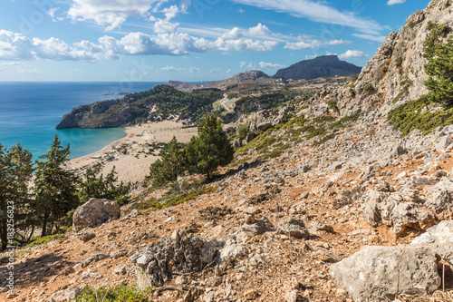 Stony landscape and a view of the Tsambika beach on the Rhodes Island, Greece