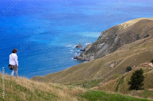 Single Woman Hiking on Rugged New Zealand Coast