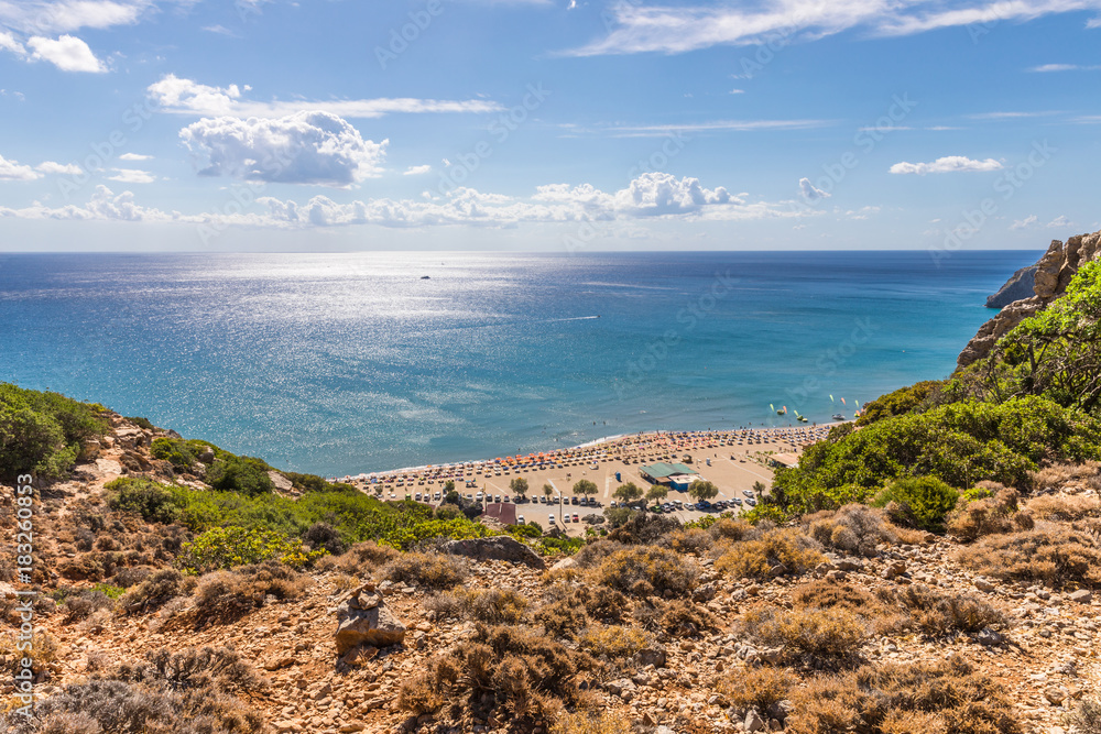 Stony landscape and a view of the Tsambika beach on the Rhodes Island, Greece
