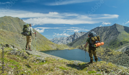 Men hiking in mountains. Siberia.