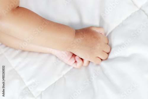 little baby hand on bed