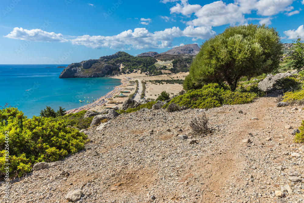 Obraz premium Stony landscape and a view of the Tsambika beach on the Rhodes Island, Greece