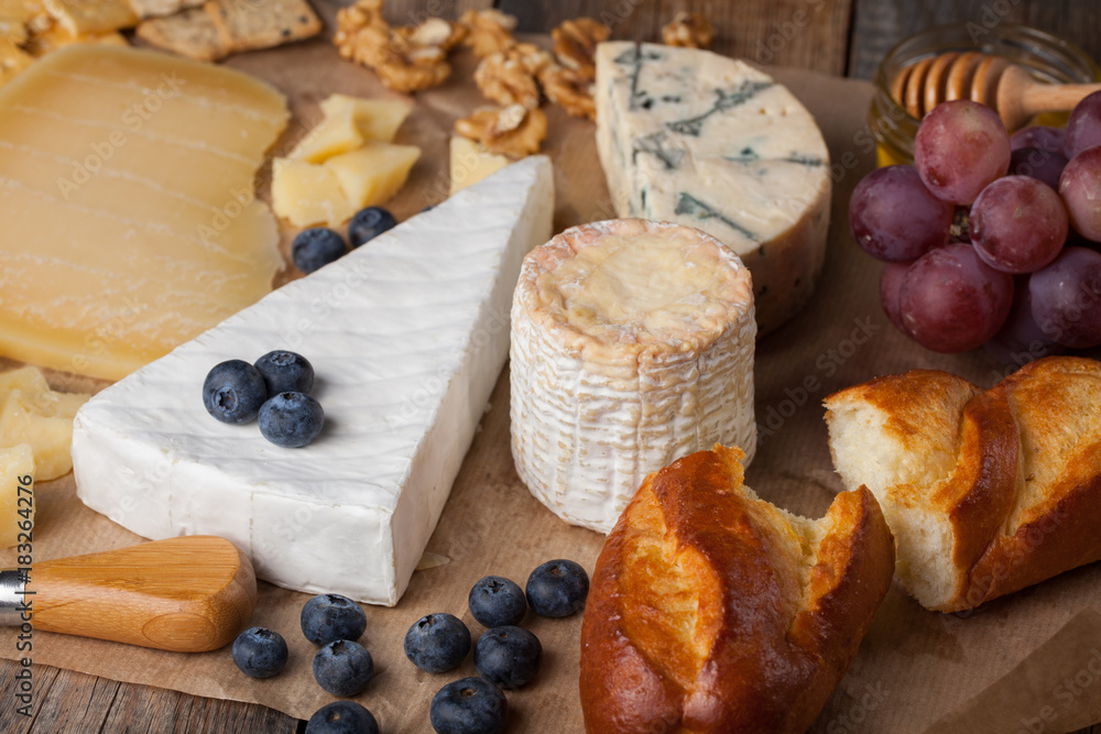 Tasting cheese dish. Food for wine and romantic, cheese delicatessen on a wooden rustic table Tasting cheese dish. Food for wine and romantic, cheese delicatessen on a wooden rustic table