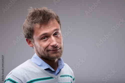 Photos Charismatic man with a rueful smile