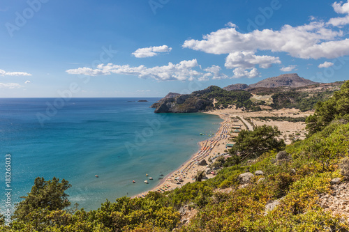 Stony landscape and a view of the Tsambika beach on the Rhodes Island, Greece © dadamira