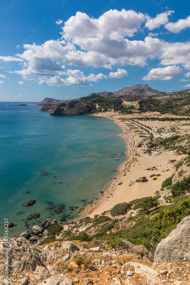 Stony landscape and a view of the Tsambika beach on the Rhodes Island, Greece